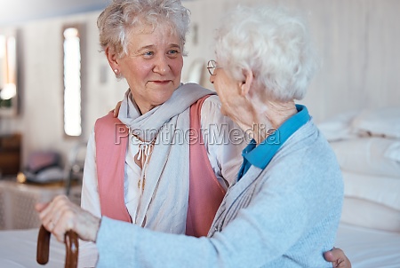 Happy,  friends and senior women talking and bonding in a bedroom together of a retirement home. Happiness,  conversation and retired elderly female best friends with a smile speaking of gossip in room.