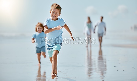 Kids,  running and beach with a family on holiday or summer vacation together outdoor in nature. Children,  travel and tourism with a brother and sister racing on the sand by the sea or ocean.