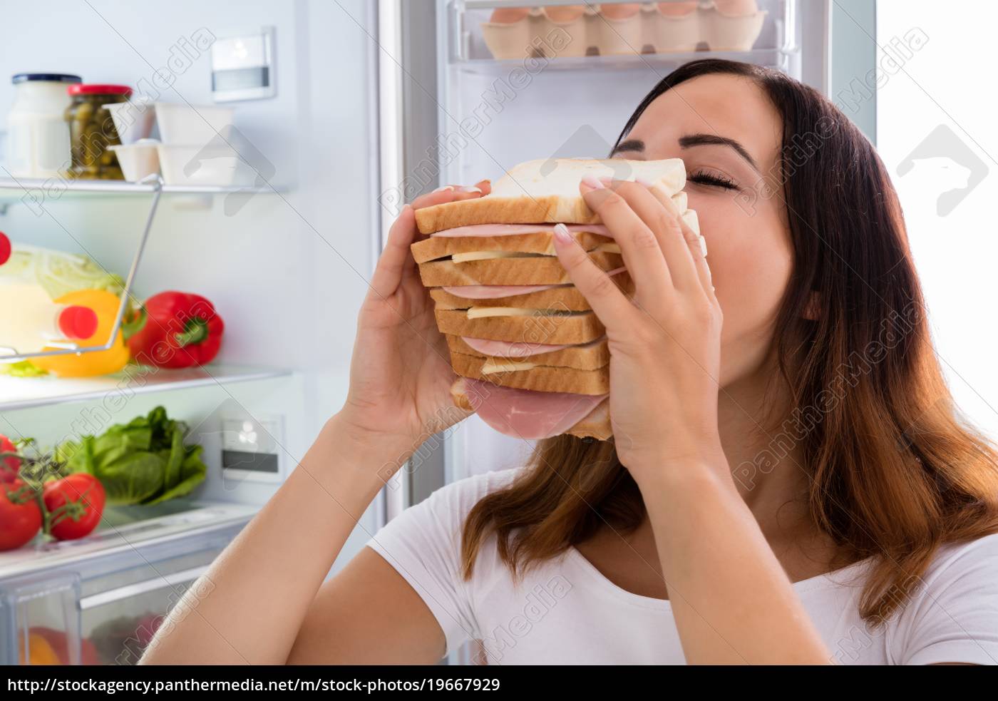 Mulher comendo sanduíche na frente da geladeira - Fotos de arquivo  #19667929 | Banco de Imagens Panthermedia