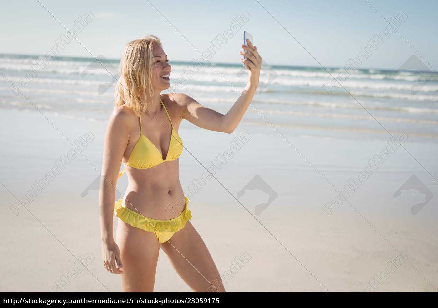 Jovem feliz de biquíni amarelo tirando selfie na praia - Fotos de arquivo  #23059175 | Banco de Imagens Panthermedia